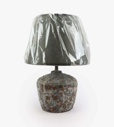 Lamp with a stone base with a mix of gray and brown colors and a blue cap